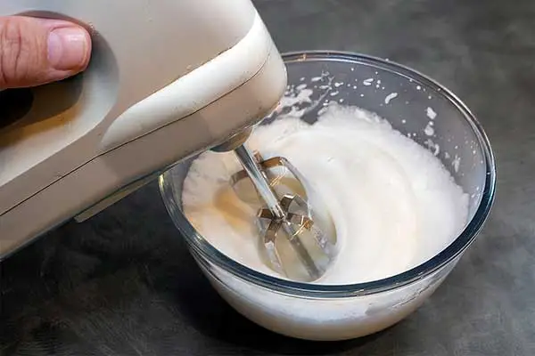 Beating egg whites to add to the waffle batter