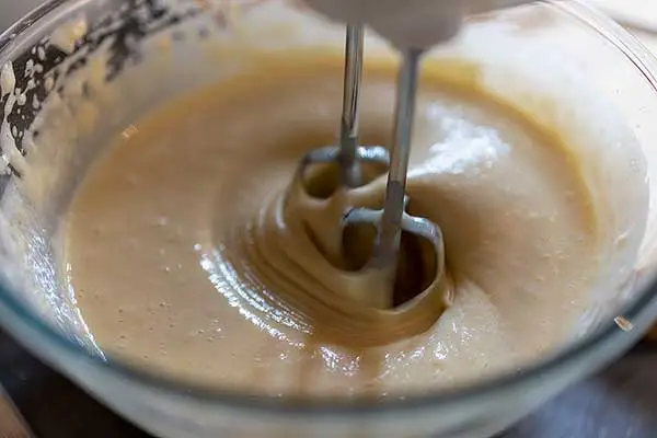 Mixing waffle batter in a glass mixing bowl