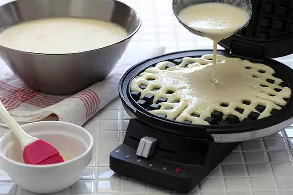 Pouring-batter-into-a-waffle-maker