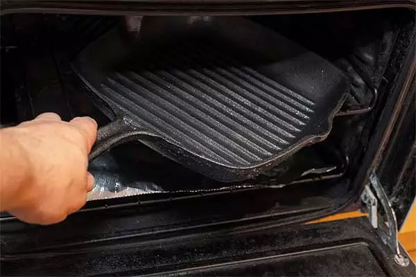 Putting the cast iron cookware into the oven