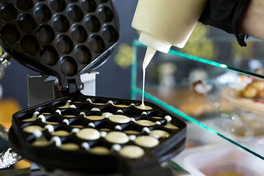 Adding-batter-to-a-bubble-waffle-maker