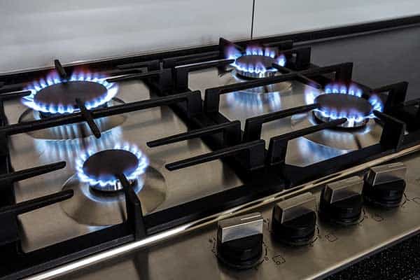 Gas-stovetop-with-lit-burners