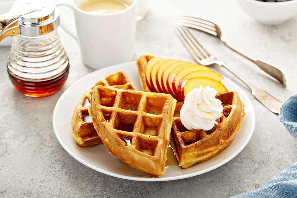 Classic Kodiak waffles with peach slices and cream