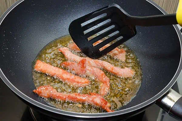 cooking bacon in a skillet