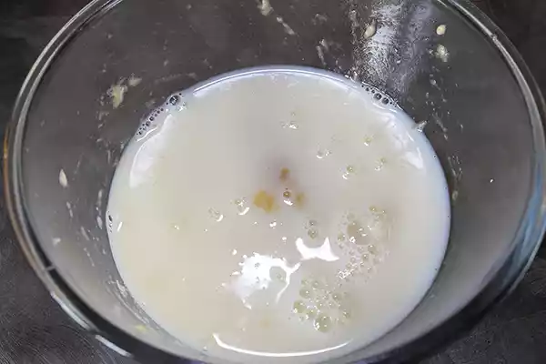 Adding milk to the mashed banana