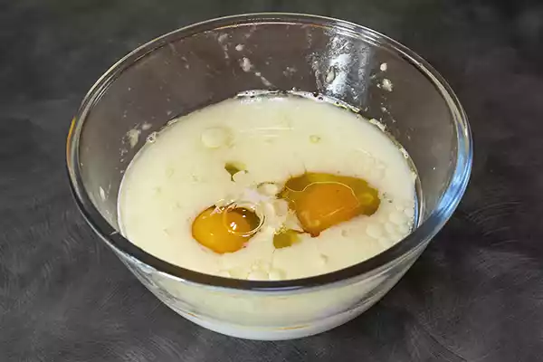 Crack two whole eggs into the bowl