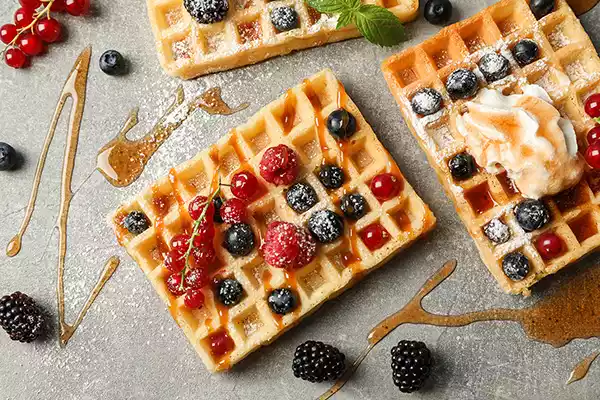Waffle with fruit and maple syrup toppings