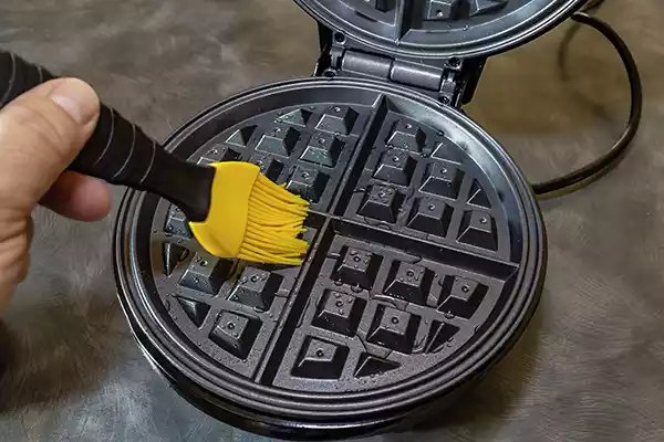 Greasing waffle maker with oil and silicone brush