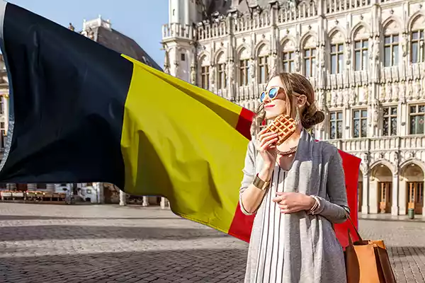 Lady eating a Brussels waffle in Belgium
