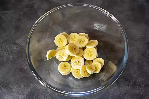 Slice the banana into a mixing bowl